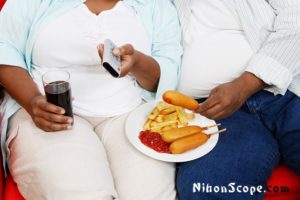 Large American Couple Eating Poorly Chosen Foods